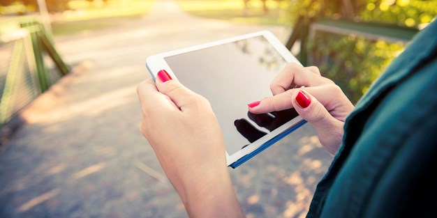 A person using a tablet. Photograph