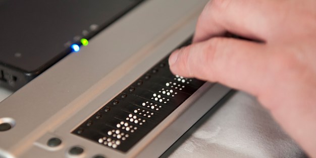 A person using a braille display. Photo