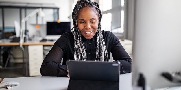 A smiling web editor at work, photo.