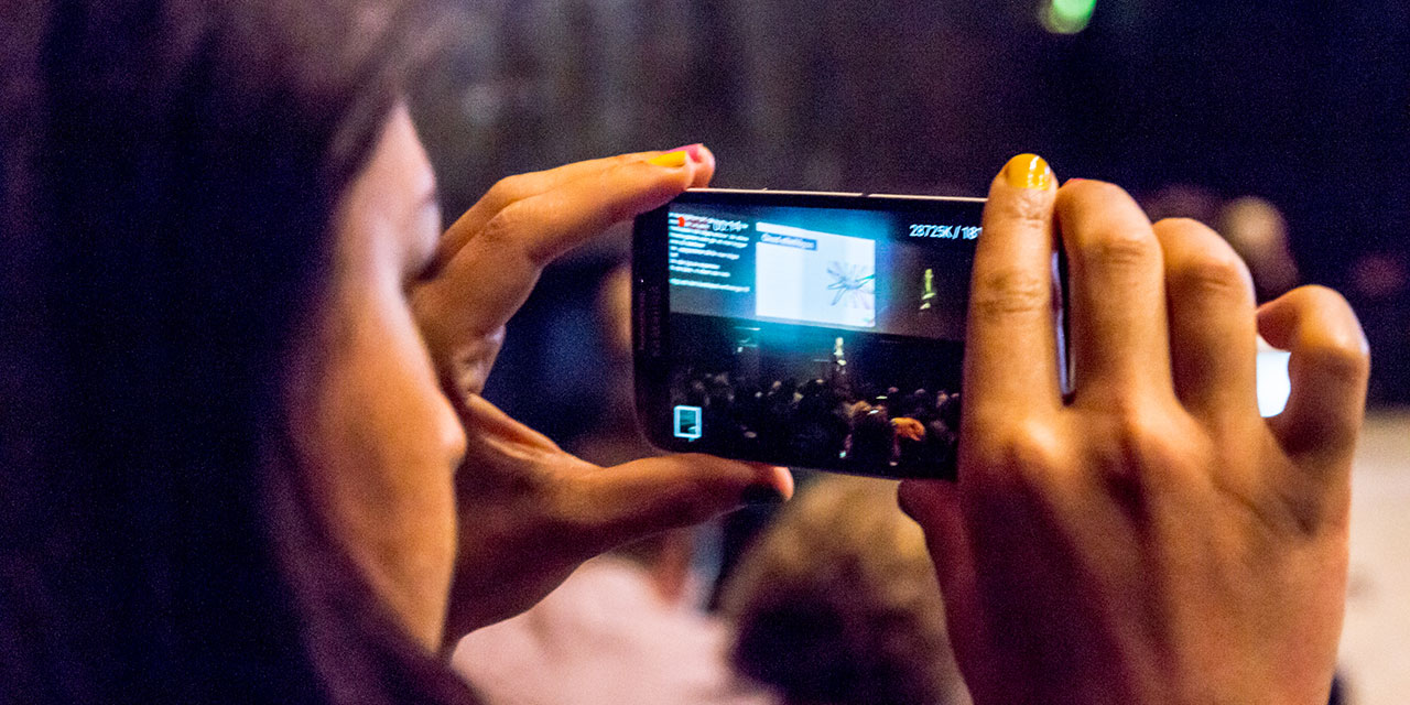 A person taking a photo during Funka Accessibility Days. Photo
