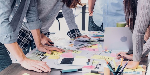 Creative meeting around a table. Photo.