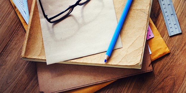 Pen and books on a desk. Photo