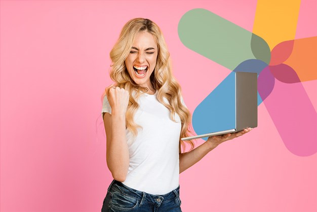 Excited woman looking at laptop