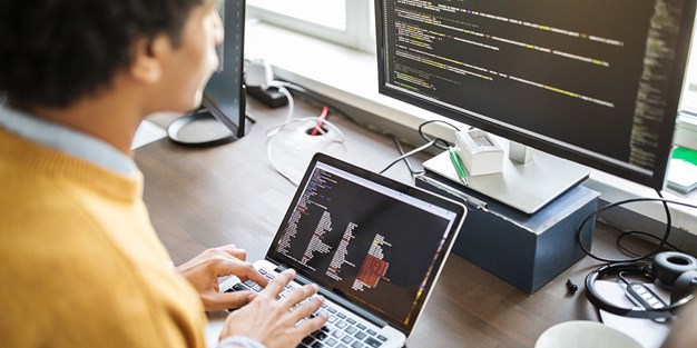 A programmer working at his computer. Photo