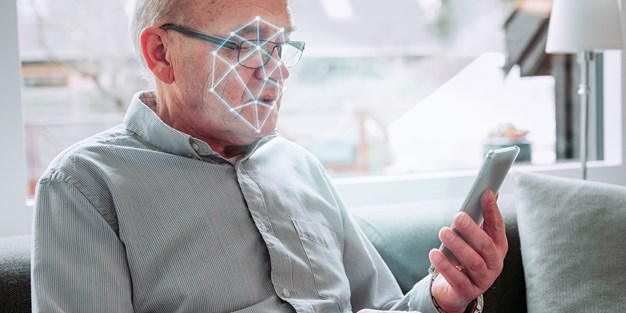 A person using a smartphone and face recognition. Photo / Illustration
