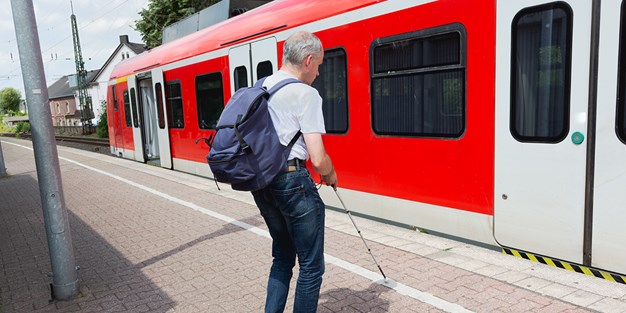 A blind person to get on a train, photo.